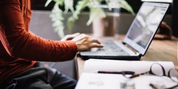 Cropped image of man typing on laptop